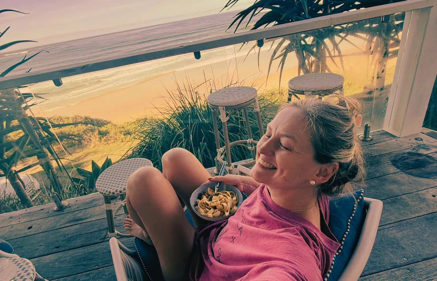 Jen relaxing on a deck overlooking the coast